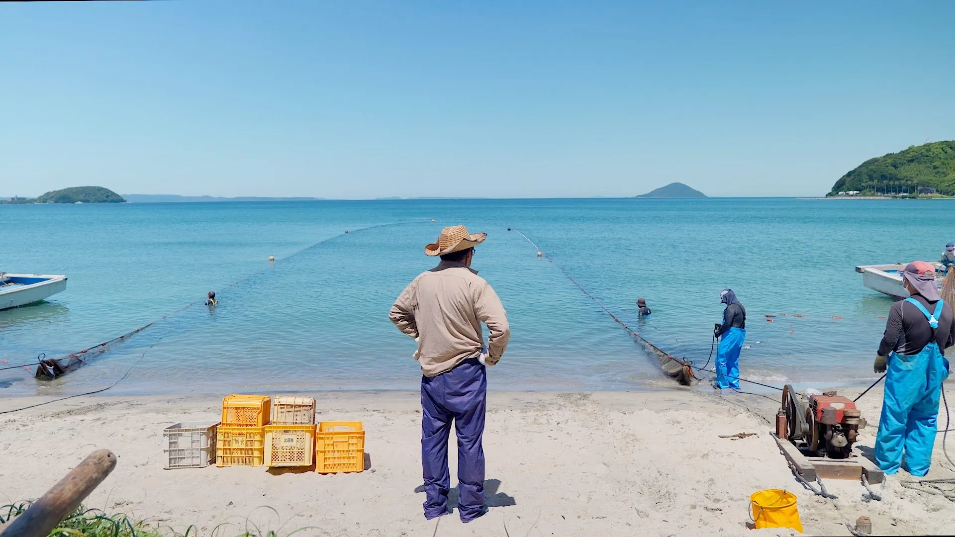 Jibiki-ami fishing at Hatae Beach, Itoshima. Jibiki-ami is purse-seine fishing technique that uses a large, wall-like net to encircle a school of fish, then closes the bottom with a drawstring to trap the fish.